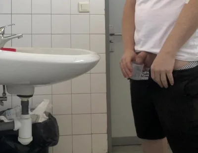 Guy Taking a Urine Sample in Hospital Toilets