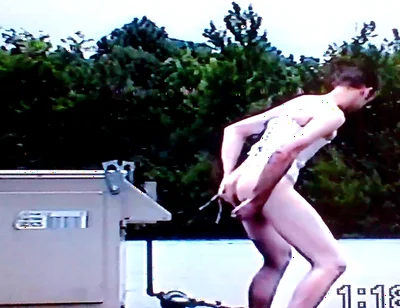 Crossdresser Riding a Giant Dildo on a Roof Top