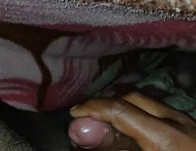 Big Boss massaging penis oil under the blanket