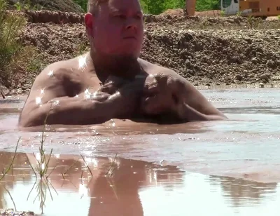 Deep, Creamy Brown Mud Bath in a Sand Pit