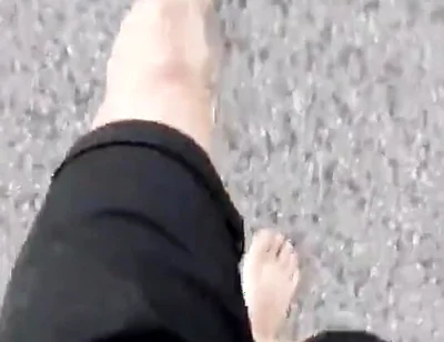 Jon Arteen Walks Barefoot on the Street Outdoors, the Boy Is Barefoot in the Crowded Tram to the Town Center
