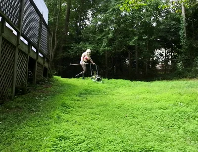 Big Fake Tits Crossdresser in Daisy Dukes Mowing Grass