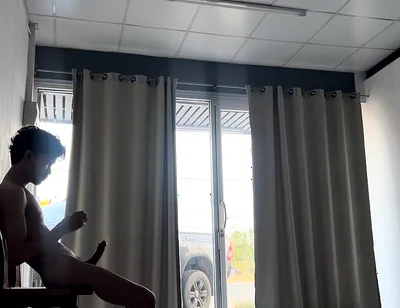 A Handsome Young Man Jerks off in Front of a Glass Door