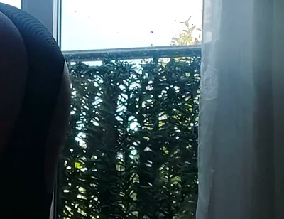 In Lingerie and Heels at the Window with a Toy