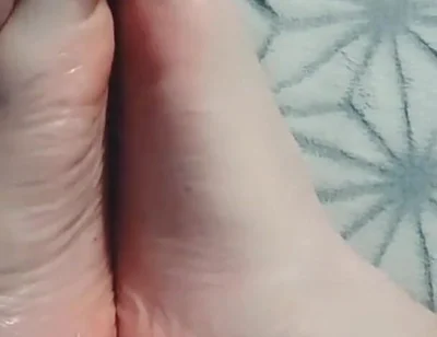 Guy Gently Massages His Feet with Oil